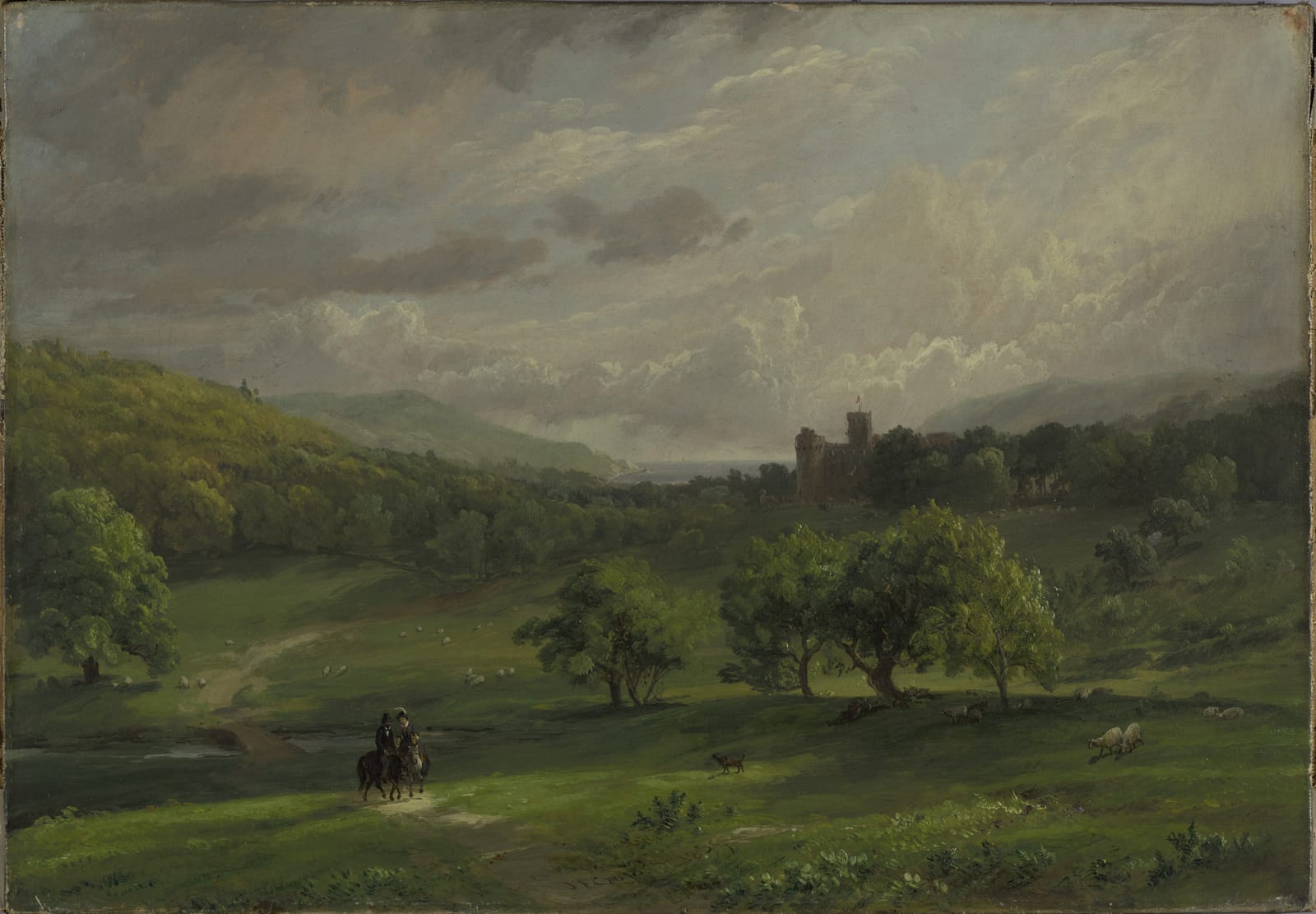 A green valley under a grey sky, with a rider on the track, trees in the middle distance and Lulworth Castle small among them.