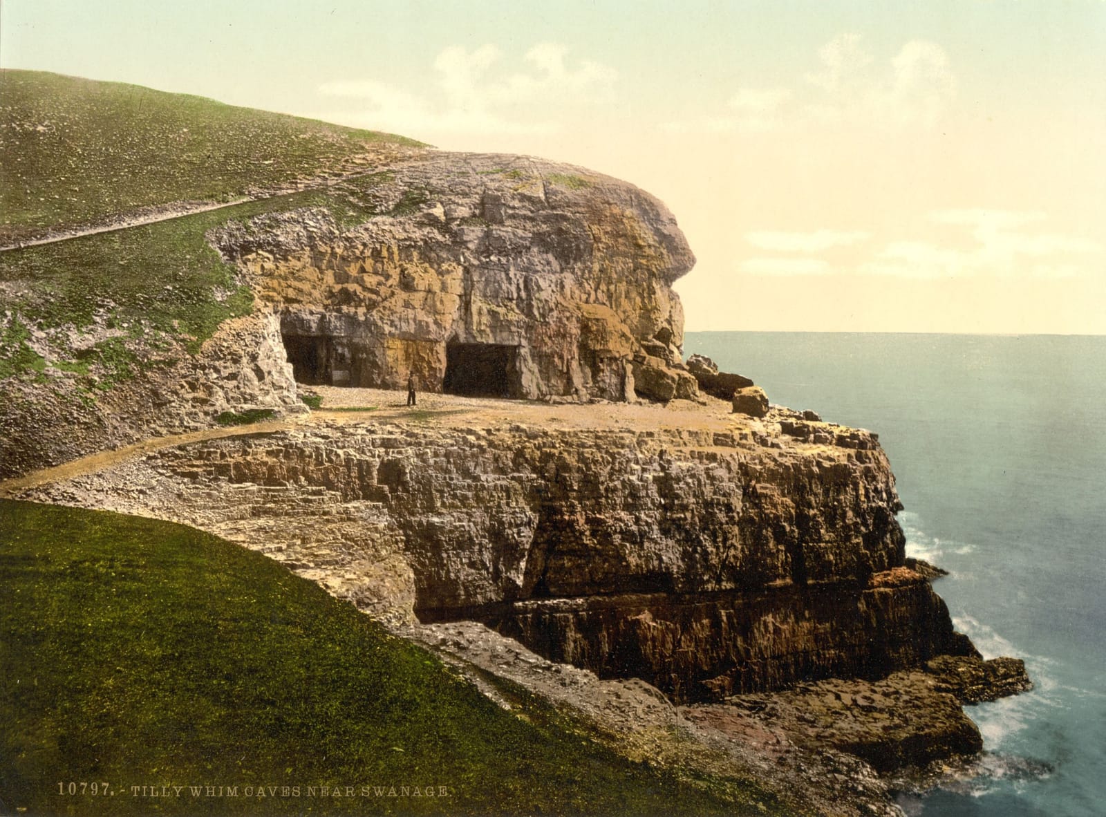 Pale limestone cliffs with the openings of old quarry caves, dropping straight into the sea.