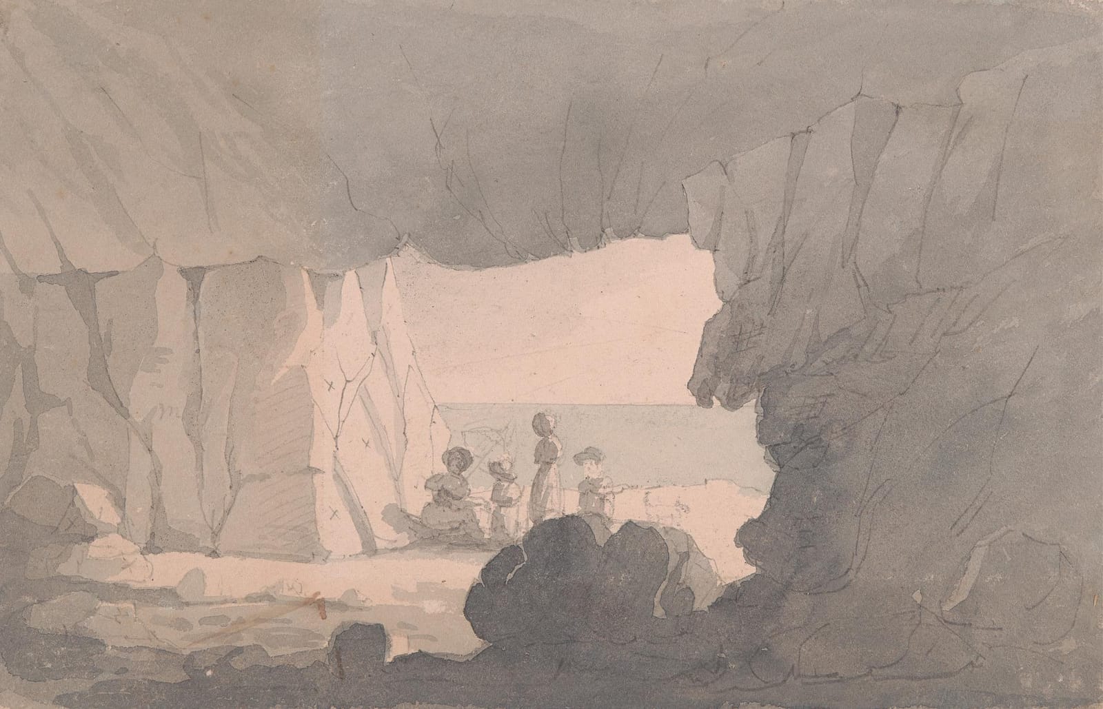 Looking out to sea from inside a great square-cut quarry cave, with figures sitting in the opening.